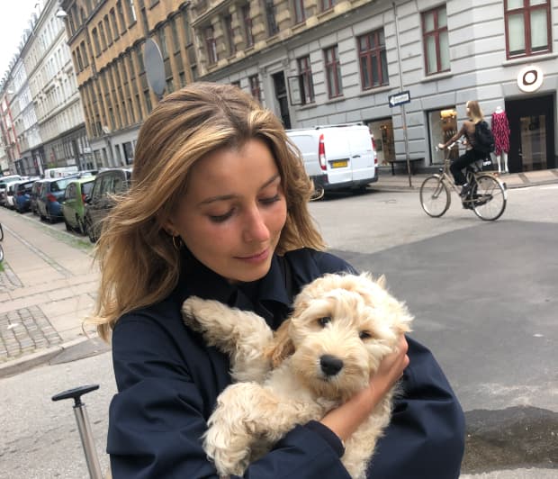 A picture of a woman holding a dog in her arms.